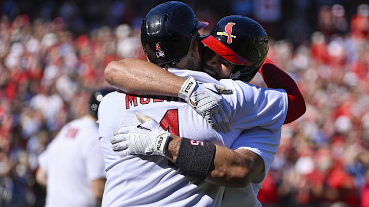 Oct 2, 2022; St. Louis, Missouri, USA;  St. Louis Cardinals first baseman Albert Pujols (5) celebrates with catcher Yadier Molina (4) after hitting a solo home run for his 702nd career home run during the third inning against the Pittsburgh Pirates at Busch Stadium. Mandatory Credit: Jeff Curry-Imagn Images