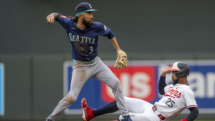 Jun 24, 2025; Minneapolis, Minnesota, USA; Seattle Mariners shortstop J.P. Crawford (3) forces out Minnesota Twins center fielder Byron Buxton (25) at second base and throws the ball to first base for a double in the first inning at Target Field.