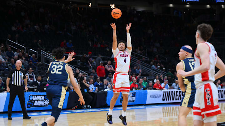 Mar 21, 2025; Seattle, WA, USA; Arizona Wildcats forward Trey Townsend (4) shoots the ball against Akron Zips forward James Okonkwo (32) during the first half in the first round of the NCAA Tournament at Climate Pledge Arena. Mandatory Credit: Steven Bisig-Imagn Images