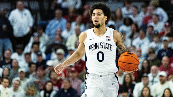 Penn State basketball guard Jahvin Carter dribbles the ball during a Nittany Lions game.