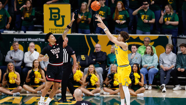 Jan 20, 2026; Waco, Texas, USA;  Baylor Bears guard Dan Skillings Jr. (0) scores a three-point basket against Texas Tech Red Raiders forward Lejuan Watts (3) during the first half at Paul and Alejandra Foster Pavilion. Mandatory Credit: Chris Jones-Imagn Images
