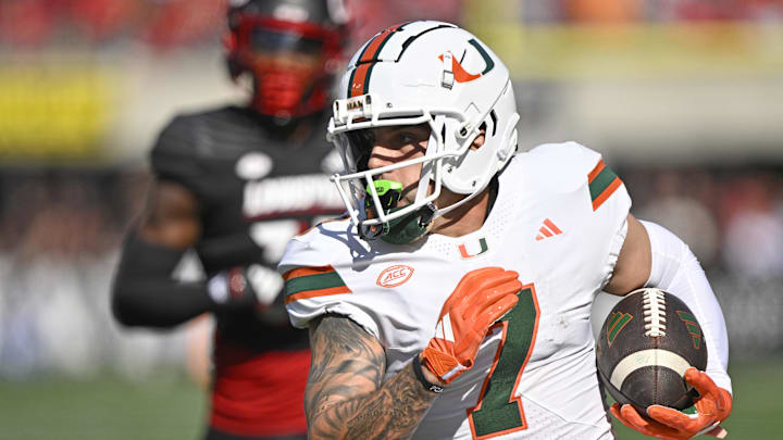 Oct 19, 2024; Louisville, Kentucky, USA;   Miami Hurricanes wide receiver Xavier Restrepo (7) runs the ball against the Louisville Cardinals during the first half at L&N Federal Credit Union Stadium. Miami defeated Louisville 52-45. Mandatory Credit: Jamie Rhodes-Imagn Images