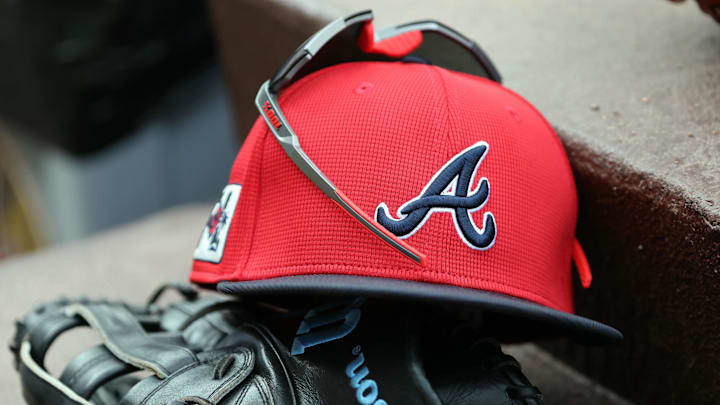 wMar 1, 2025; North Port, Florida, USA; A detail view of Atlanta Braves hat, sunglasses and glove in the dugout during the fifth inning at CoolToday Park. Mandatory Credit: Kim Klement Neitzel-Imagn Images