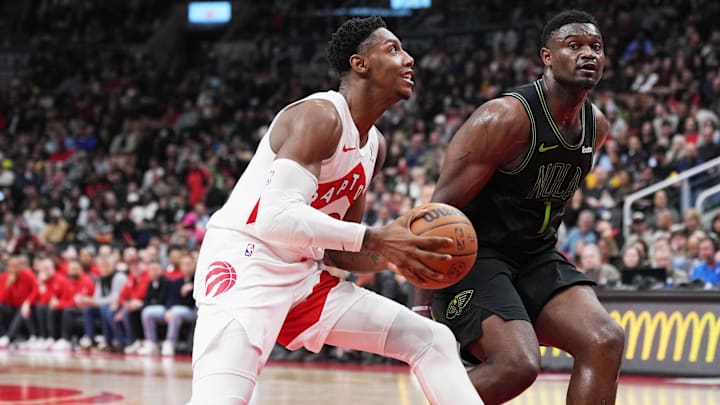 Mar 5, 2024; Toronto, Ontario, CAN; Toronto Raptors guard RJ Barrett (9) drives to the basket as New Orleans Pelicans forward Zion Williamson (1) tries to defend during the second quarter at Scotiabank Arena. Mandatory Credit: Nick Turchiaro-Imagn Images