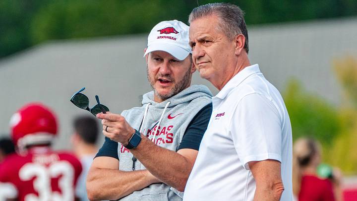 Arkansas Razorbacks football coach Ryan Silvefield speaks with basketball coach John Calipari during practice on Wednesday, Aug. 19. Arkansas Razorbacks football coach Ryan Silvefield speaks with basketball coach John Calipari during practice on Wednesday, Aug. 19.