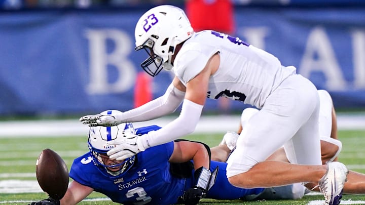 Elder Panthers defensive back jumps on a loose ball in the first half of a high school football game between the St. Xavier Bombers and Elder Panthers, Friday, Sept. 26, 2025, at RDI Stadium in Cincinnati.