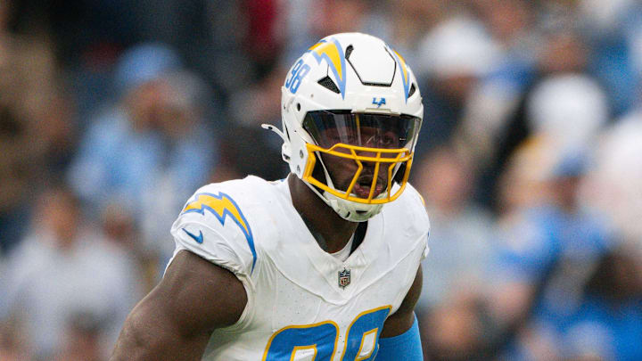 Nov 2, 2025; Nashville, Tennessee, USA;  Los Angeles Chargers linebacker Odafe Oweh (98) celebrates his sack with linebacker Tuli Tuipulotu (45) against the Tennessee Titans during the second half at Nissan Stadium. Mandatory Credit: Steve Roberts-Imagn Images