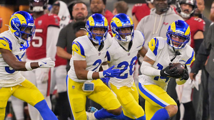 Nov 23, 2025; Inglewood, California, USA; Los Angeles Rams cornerback Cobie Durant (14) runs with the ball after intercepting a pass thrown by Tampa Bay Buccaneers quarterback Baker Mayfield (not pictured) during the first quarter at SoFi Stadium. Mandatory Credit: Kiyoshi Mio-Imagn Images