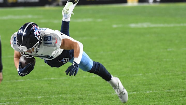 Nov 2, 2023; Pittsburgh, Pennsylvania, USA; Tennessee Titans wide receiver Kyle Phillips (18) goes air born after a catch against the Pittsburgh Steelers during the second quarter at Acrisure Stadium. Mandatory Credit: Philip G. Pavely-Imagn Images