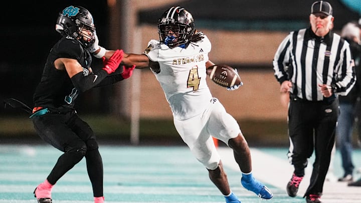 Atherton High School's Garyon Hobbs (4) put a stiff arm on North Oldham High School's Andrew Davis (0) while running for yardage as the Ravens rolled past North Oldham 42-13 KHSAA football on Friday night in Goshen, Kentucky. Hobbs had kick return touchdown in the second half. Oct. 31, 2025