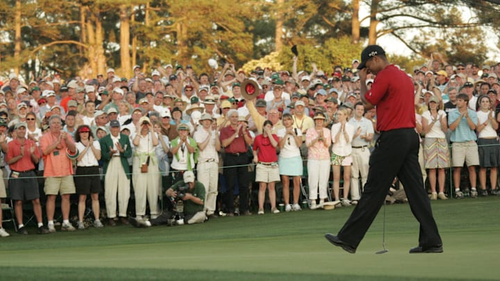 Tiger Woods walks off the 18th green after winning his fourth Masters on April 10, 2005.