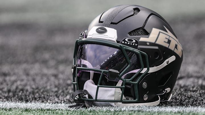 Dec 7, 2025; East Rutherford, New Jersey, USA; A general view of a Gotham City football rivalries helmet resting on the field before the game against the Miami Dolphins at MetLife Stadium. Mandatory Credit: Vincent Carchietta-Imagn Images