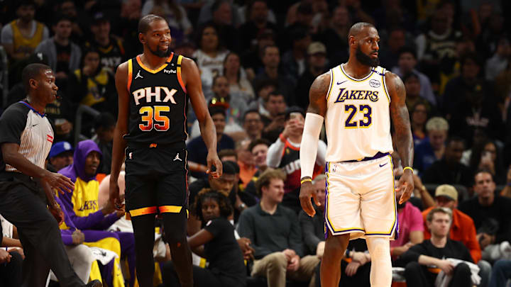 Nov 26, 2024; Phoenix, Arizona, USA; Los Angeles Lakers forward LeBron James (23) against Phoenix Suns forward Kevin Durant (35) during an NBA Cup game at Footprint Center. Mandatory Credit: Mark J. Rebilas-Imagn Images