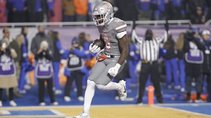 Dec 6, 2024; Boise, ID, USA; UNLV Rebels running back Greg Burrell (5) scores a touchdown during the second half against the Boise State Broncos at Albertsons Stadium. Boise State beats  UNLV 21-7. Mandatory Credit: Brian Losness-Imagn Images

