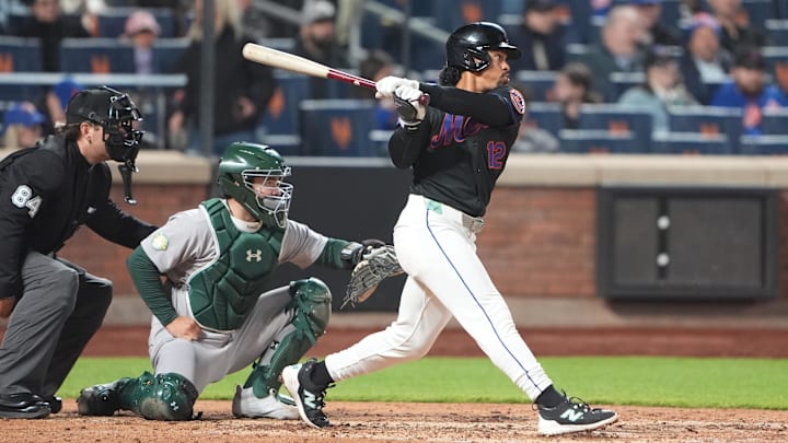 Apr 10, 2026; New York City, New York, USA; New York Mets shortstop Francisco Lindor (12) hits a single against the Athletics during the sixth inning at Citi Field. Mandatory Credit: Gregory Fisher-Imagn Images