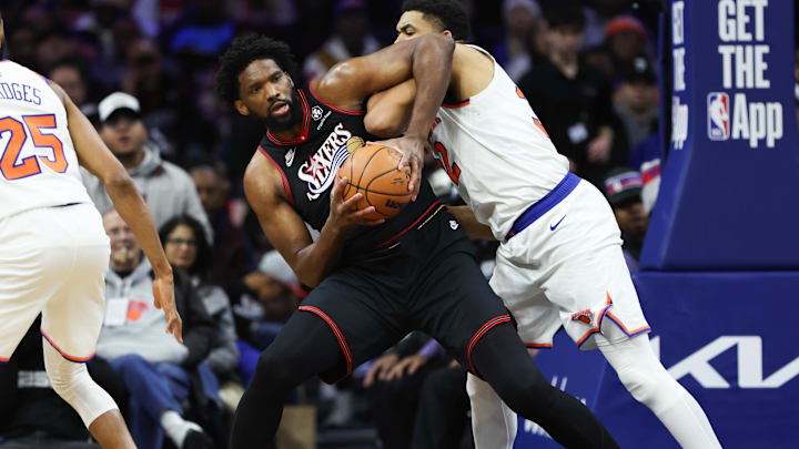 Jan 24, 2026; Philadelphia, Pennsylvania, USA; Philadelphia 76ers center Joel Embiid (21) controls the ball against New York Knicks center Karl-Anthony Towns (32) during the second quarter at Xfinity Mobile Arena. Mandatory Credit: Bill Streicher-Imagn Images
