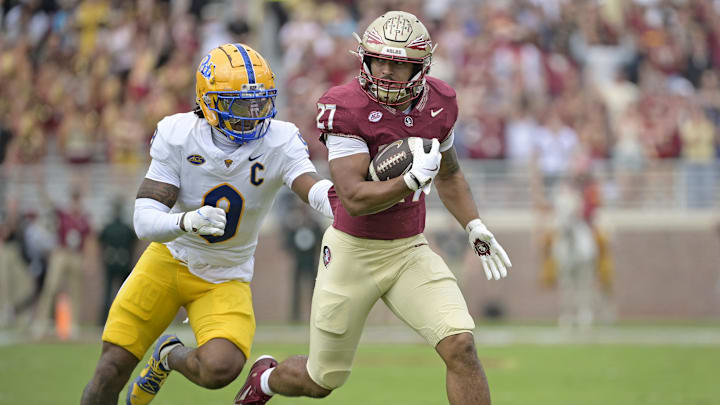 Oct 11, 2025; Tallahassee, Florida, USA; Florida State Seminoles running back Gavin Sawchuk (27) runs the ball past Pittsburgh Panthers linebacker Kyle Louis (9) during the first half at Doak S. Campbell Stadium. Mandatory Credit: Melina Myers-Imagn Images Oct 11, 2025; Tallahassee, Florida, USA; Florida State Seminoles running back Gavin Sawchuk (27) runs the ball past Pittsburgh Panthers linebacker Kyle Louis (9) during the first half at Doak S. Campbell Stadium. Mandatory Credit: Melina Myers-Imagn Images