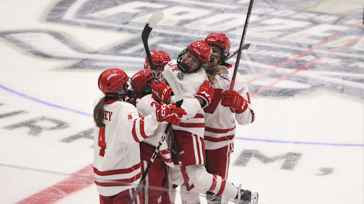 Wisconsin's Casey O'Brien jumps into a group hug from her teammates after assisting Kirsten Simms on a first-period goal during a NCAA women's hockey national semifinal at Whittemore Center Arena in Durham, New Hampshire on Friday March 22, 2024.