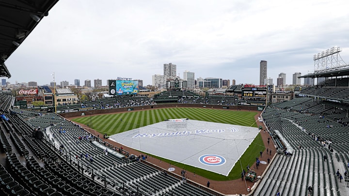 Apr 20, 2025; Chicago, Illinois, USA; A rain tarp keeps the infield dry before a delayed baseball game between the Chicago Cubs and Arizona Diamondbacks at Wrigley Field. Mandatory Credit: Kamil Krzaczynski-Imagn Images