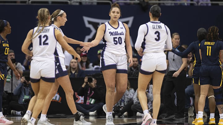 Mar 9, 2024; Kansas City, MO, USA; Teammates high five Kansas State Wildcats center Ayoka Lee (50).