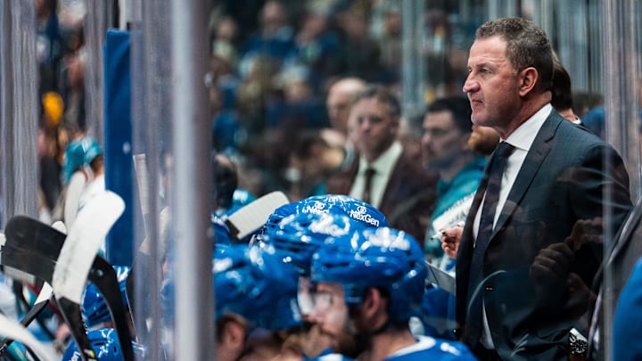 Dec 27, 2025; Vancouver, British Columbia, CAN; Vancouver Canucks head coach Adam Foote on the bench against the San Jose Sharks in the third period at Rogers Arena. Mandatory Credit: Bob Frid-Imagn Images