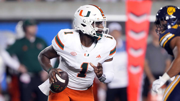 Oct 5, 2024; Berkeley, California, USA; Miami Hurricanes quarterback Cam Ward (1) scrambles against the California Golden Bears during the first quarter at California Memorial Stadium. Mandatory Credit: Darren Yamashita-Imagn Images