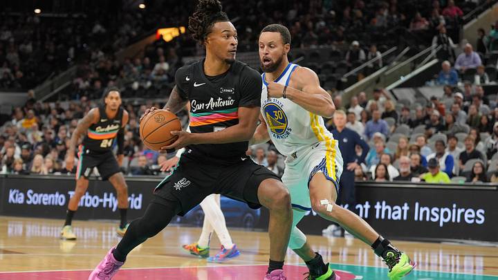Nov 12, 2025; San Antonio, Texas, USA;  San Antonio Spurs guard Stephon Castle (5) dribbles against Golden State Warriors guard Stephen Curry (30) in the first half at Frost Bank Center. Mandatory Credit: Daniel Dunn-Imagn Images