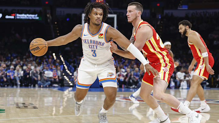 Oct 17, 2024; Oklahoma City, Oklahoma, USA; Oklahoma City Thunder forward Dillon Jones (3) moves the ball around Atlanta Hawks guard Garrison Mathews (24) during the second half at Paycom Center. Mandatory Credit: Alonzo Adams-Imagn Images