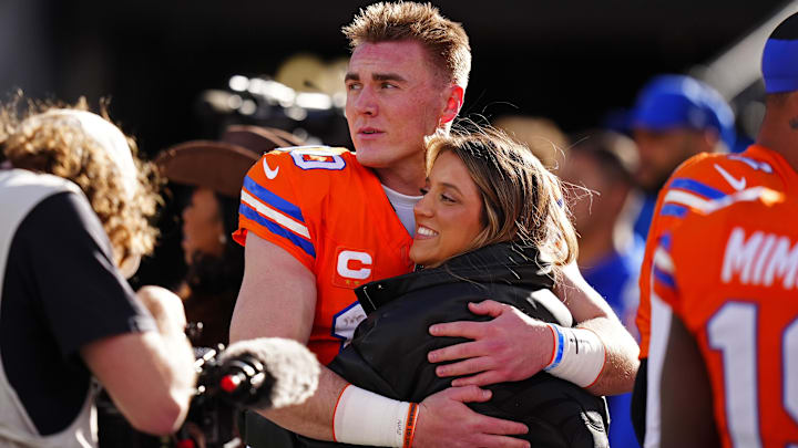 Jan 4, 2026; Denver, Colorado, USA; Denver Broncos quarterback Bo Nix (10) hugs wife, Izzy Nix before the game against the Los Angeles Chargers at Empower Field at Mile High.