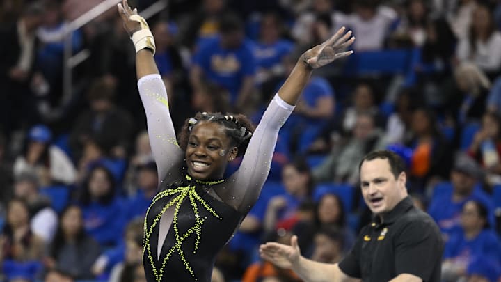 Mar 30, 2023; Los Angeles, CA, USA;  Amari Celestine of Missouri completes her floor exercise routine as coach Shannon Welker applauds during the NCAA Women's Gymnastics Los Angeles Regional at Pauley Pavilion. Mandatory Credit: Robert Hanashiro-Imagn Images