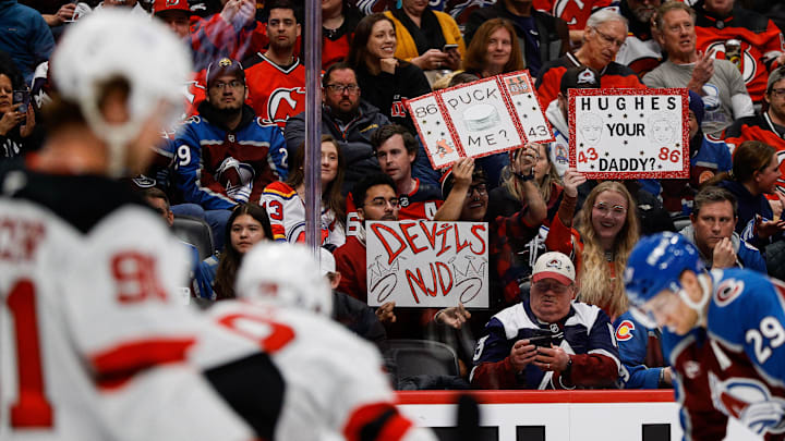 Feb 26, 2025; Denver, Colorado, USA; New Jersey Devils fans hold up signs in the second period against the Colorado Avalanche at Ball Arena. Mandatory Credit: Isaiah J. Downing-Imagn Images