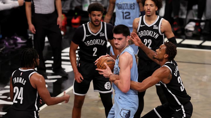Nov 4, 2024; Brooklyn, New York, USA; Memphis Grizzlies center Zach Edey (14) fights for the ball against Brooklyn Nets center Nic Claxton (33) and guard Cam Thomas (24) and forwards Cameron Johnson (2) and Jalen Wilson (22) during the first quarter at Barclays Center. Mandatory Credit: Brad Penner-Imagn Images