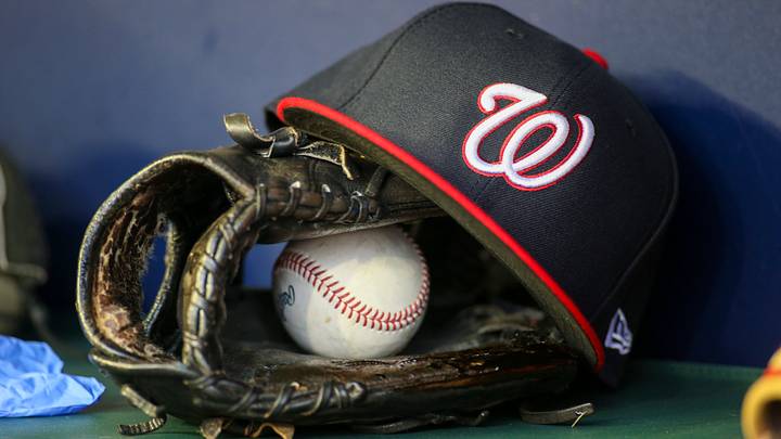 Dark blue Washington Nationals hat on top of a black mitt Dark blue Washington Nationals hat on top of a black mitt