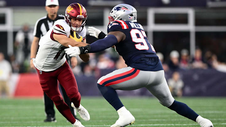 Aug 8, 2025; Foxborough, Massachusetts, USA; New England Patriots defensive end Milton Williams (97) tackles Washington Commanders wide receiver Luke McCaffrey (11) during the first half at Gillette Stadium. Mandatory Credit: Brian Fluharty-Imagn Images
