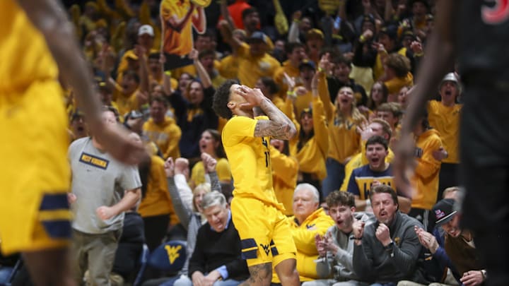 Feb 19, 2025; Morgantown, West Virginia, USA; West Virginia Mountaineers guard Jonathan Powell (11) celebrates after a made three point shot during the second half against the Cincinnati Bearcats at WVU Coliseum. Mandatory Credit: Ben Queen-Imagn Images