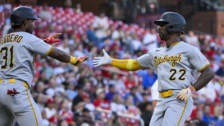 Aug 26, 2025; St. Louis, Missouri, USA;  Pittsburgh Pirates designated hitter Andrew McCutchen (22) is congratulated by shortstop Liover Peguero (31) after scoring against the St. Louis Cardinals during the first inning at Busch Stadium. Mandatory Credit: Jeff Curry-Imagn Images