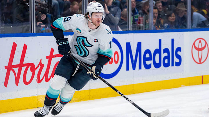 Dec 28, 2024; Vancouver, British Columbia, CAN; Seattle Kraken forward Jared McCann (19) handles the puck against the Vancouver Canucks in the second period at Rogers Arena. Mandatory Credit: Bob Frid-Imagn Images