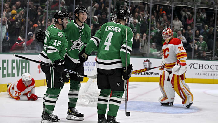 Dec 8, 2024; Dallas, Texas, USA; Dallas Stars center Colin Blackwell (15) and left wing Jason Robertson (21) and defenseman Miro Heiskanen (4) celebrates a goal scored by Robertson against Calgary Flames goaltender Dustin Wolf (32) during the second period at the American Airlines Center. Mandatory Credit: Jerome Miron-Imagn Images