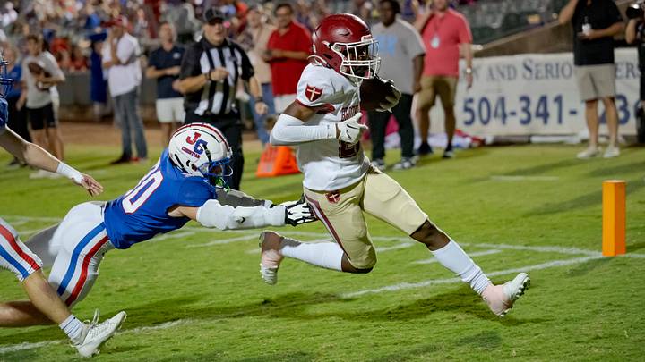 Oct 27, 2023; Metairie, LA, USA; Brother Martin Crusaders wide receiver Easton Royal (23) scores a touchdown against John Curtis Patriots linebacker Benjamin Barron (30) during the first quarter at The Shrine on Airline. Mandatory Credit: Matthew Hinton-USA TODAY Sports Oct 27, 2023; Metairie, LA, USA; Brother Martin Crusaders wide receiver Easton Royal (23) scores a touchdown against John Curtis Patriots linebacker Benjamin Barron (30) during the first quarter at The Shrine on Airline. Mandatory Credit: Matthew Hinton-USA TODAY Sports