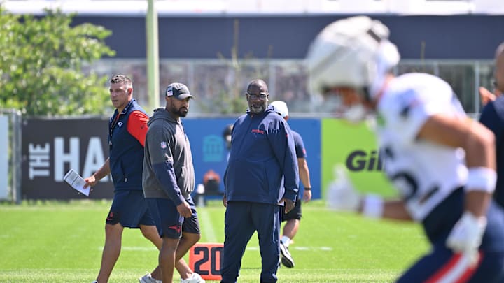 Jul 28, 2025; Foxborough, MA, USA; New England Patriots head coach Mike Vrabel (red sleeves and defensive coordinator Terrell Williams (blue pants) watch the team during training camp at Gillette Stadium. Mandatory Credit: Eric Canha-Imagn Images
