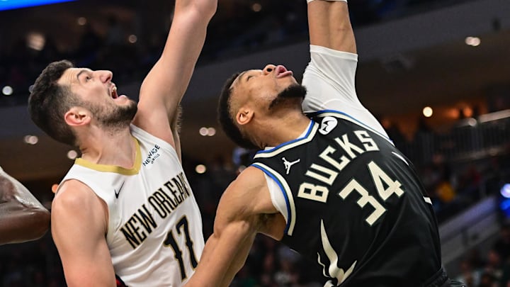 Apr 10, 2025; Milwaukee, Wisconsin, USA: Milwaukee Bucks forward Giannis Antetokounmpo (34) and New Orleans Pelicans forward Karlo Matkovic (17) reach for a rebound in the second quarter at Fiserv Forum. Mandatory Credit: Benny Sieu-Imagn Images
