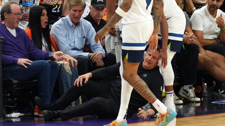 Apr 28, 2024; Phoenix, Arizona, USA; Minnesota Timberwolves head coach Chris Finch is tended to Apr 28, 2024; Phoenix, Arizona, USA; Minnesota Timberwolves head coach Chris Finch is tended to