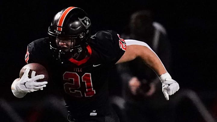 St. Xavier Tigers safety Adam Buehner (8) attempts to tackle Ryle Raiders running back Jacob Savage (21) in the first quarter of a high school football game between the Ryle Raiders and St. Xavier Tigers, Friday, Nov. 15, 2024, at Clifford R. Borland, Sr. Stadium in Union, Ky.