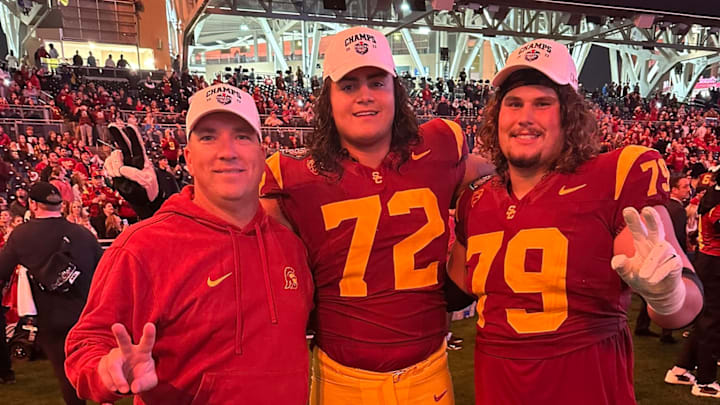 USC offensive line coach Josh Henson posing with Elijah Paige (72) and Jonah Monheim (79)