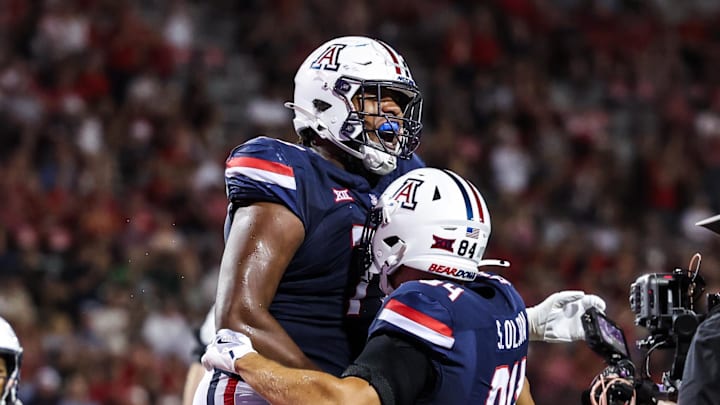 Aug 30, 2025; Tucson, Arizona, USA; Arizona Wildcats offensive lineman Michael Wooten (77) celebrates with tight end Sam Olson (84) during the third quarter of the game against the Hawaii Rainbow Warriors at Arizona Stadium. Mandatory Credit: Aryanna Frank-Imagn Images