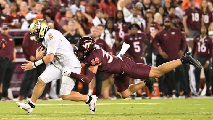 Sep 6, 2025; Blacksburg, Virginia, USA; Virginia Tech Hokies linebacker Michael Short (30) tackles Vanderbilt Commodores quarterback Diego Pavia (2) as he runs the ball during the third quarter at Lane Stadium. Mandatory Credit: Brian Bishop-Imagn Images