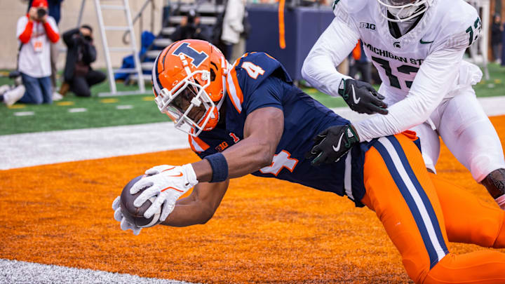 Illinois receiver Zakhari Franklin (4) hauls in a four-yard touchdown reception in the second half of the Illini's matchup with Michigan State on Saturday at Memorial Stadium in Champaign, Illinois.