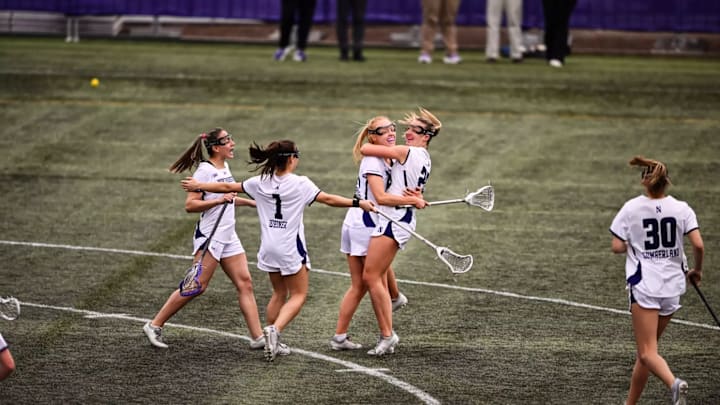 Northwestern women's lacrosse players celebrate after a goal against Oregon on April 13, 2025.