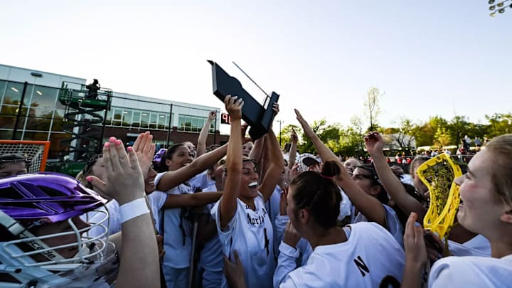 Northwestern celebrates with the trophy.