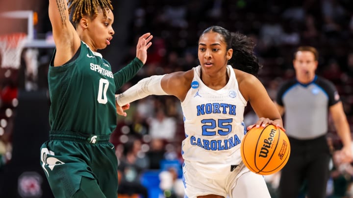 Mar 22, 2024; Columbia, SC, USA; North Carolina Tar Heels guard Deja Kelly (25) drives around Michigan State Spartans guard DeeDee Hagemann (0) in the second half at Colonial Life Arena.